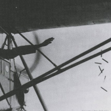 Vintage photograph of a hand throwing pens from an airplane.