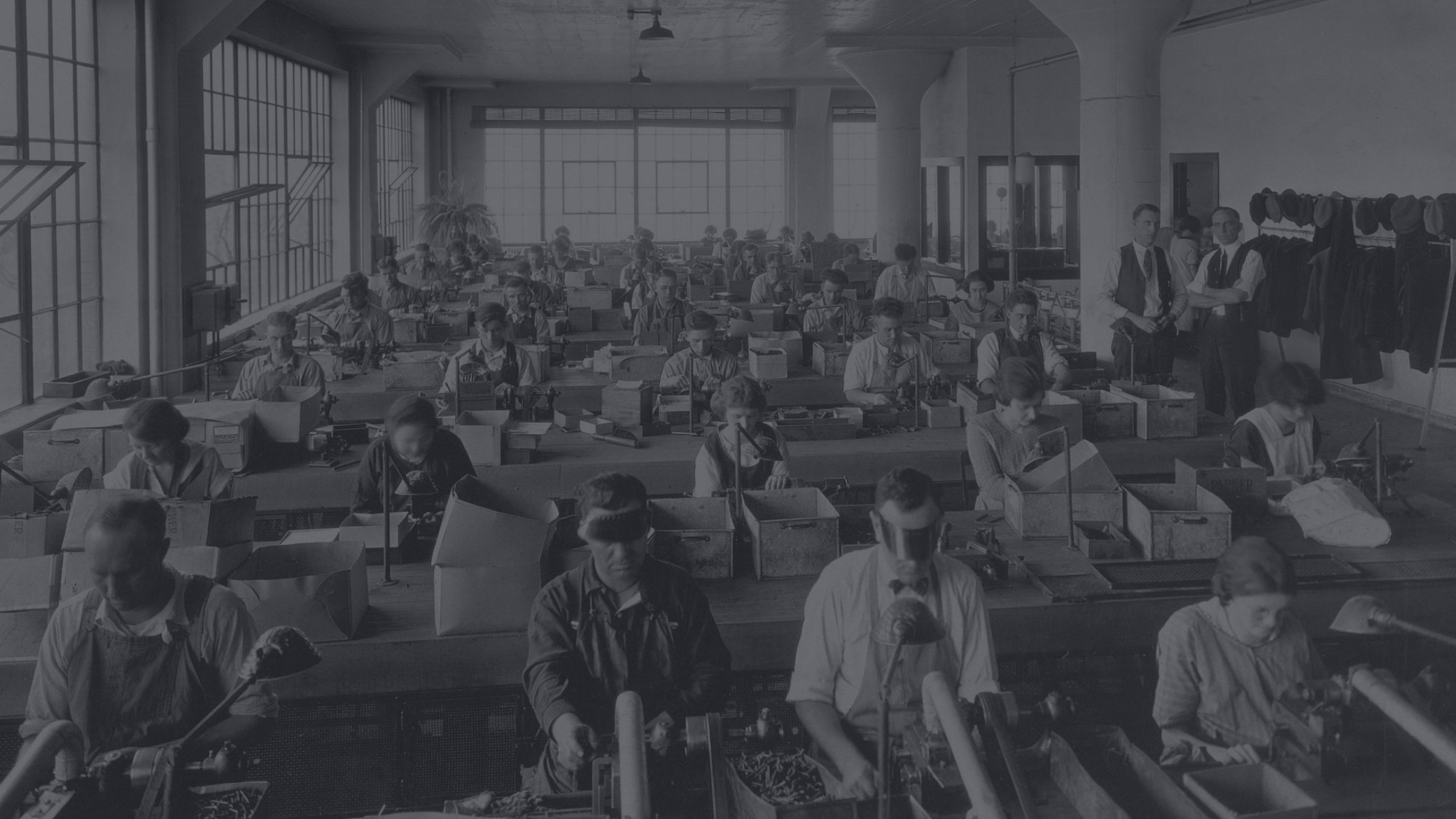 Rows of workers creating pens in a factory.
